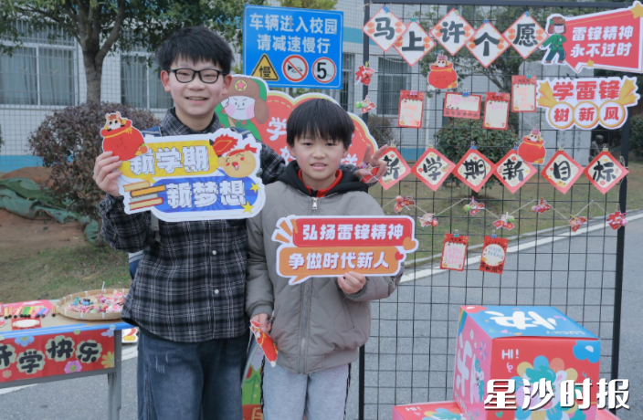 青山铺镇中心小学孩子们手持“新学期 新梦想”“学习雷锋好榜样”等创意手牌合影。