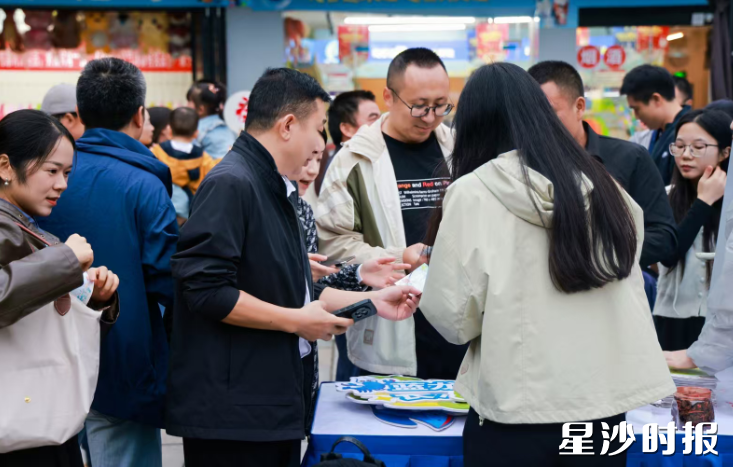 众多市民游客游逛在20个北山非遗、村咖、民宿等特色摊位前，并参与现场互动小游戏。