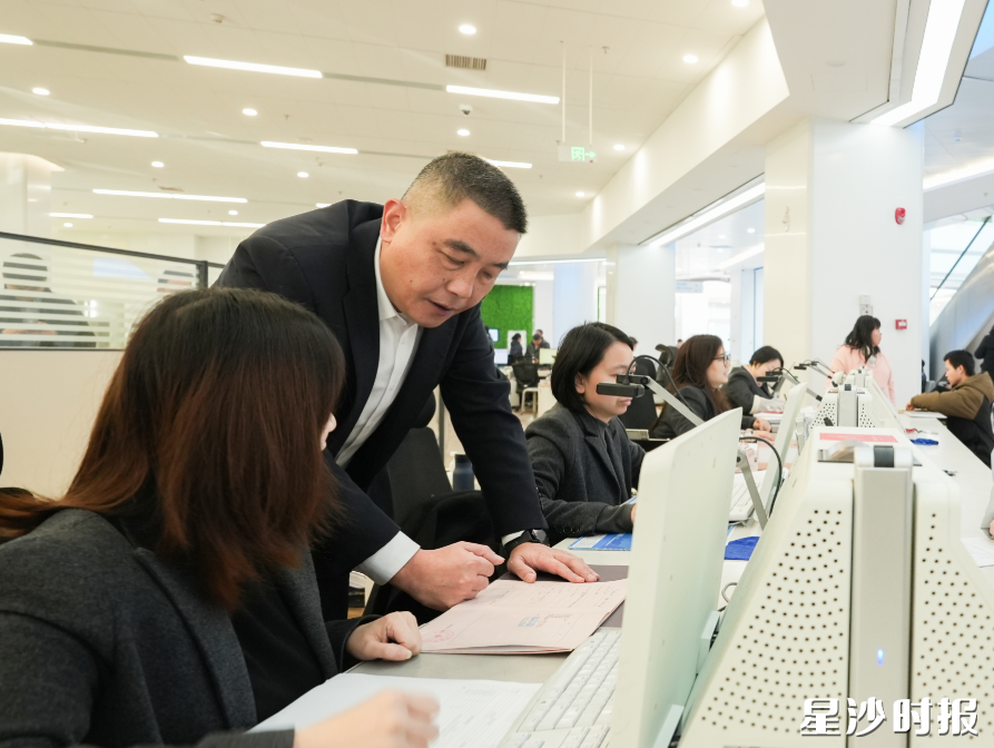 局长在窗口了解办理业务的情况。